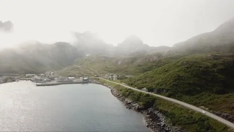 Flying over a river next to a road near the mountains in Norway Stock Footage 224138556