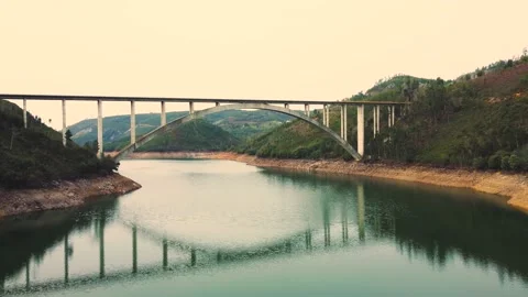 Flying over the river, pass under the bridge, reveal a beautiful landscape Video stock 177621906