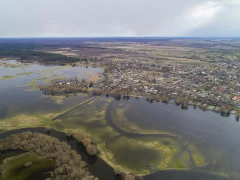 Flying over the river in the spring flood. Flooding of fields of villages. Stock Photos