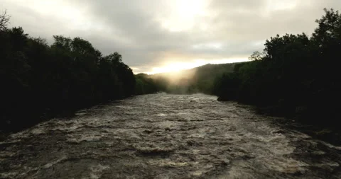 Flying over a river at sunrise Stock Footage 321636114