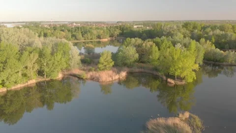 Flying over a river in the sunset with small islands and trees Stock Footage 232486813