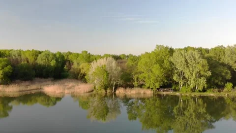 Flying over a river in the sunset with small islands and trees Stock Footage 232486967