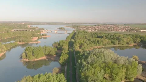 Flying over a river in the sunset with small islands and trees Stock Footage 232486999