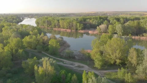 Flying over a river in the sunset with small islands and trees Stock Footage 232487018