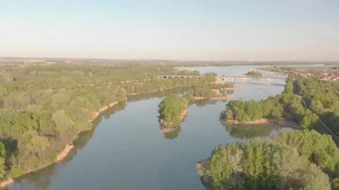 Flying over a river in the sunset with small islands and trees Stock Footage 232487251
