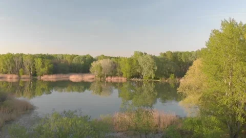 Flying over a river in the sunset with small islands and trees Stock Footage 232487287