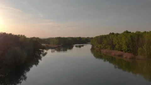 Flying over a river in the sunset with small islands and trees Stock Footage 232487292