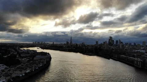 Flying over river Thames as the dramatic stormy dark, clouds gather over Stock Footage 160797381