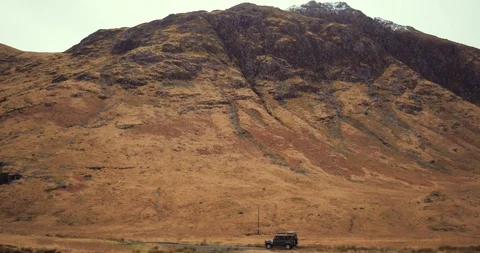 Flying over river tracking car driving through mountains drone aerial 4K Stock Footage 104583500