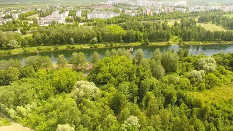 Flying over the river with trees on the background of the city. 動画素材 109461465
