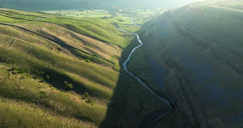 Flying over a river in a valley in Yorkshire Dales Stock Footage 335200767