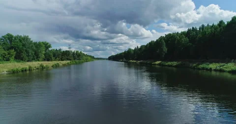 Flying over river water. Forest at summer sunny day, sky reflecting in water Stock Footage 157833767