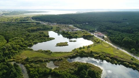 Flying over Rivers, Lakes and Swamps. Road near the Forest and a Small Recreatio Stock Footage 127791004