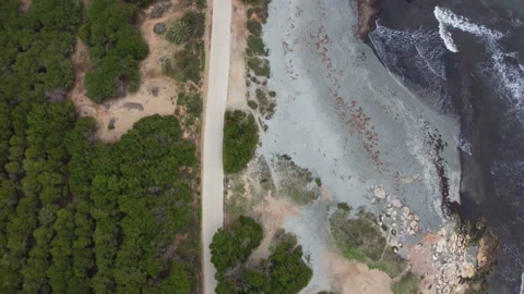 Flying over the road and the waves of the sea 4k Video stock 173032522