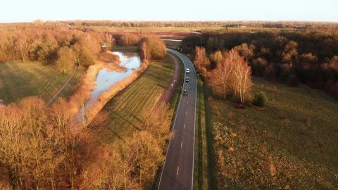 Flying over a road crossing through nature 4K Video stock 91274763