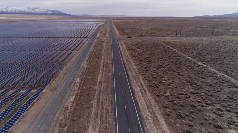 Flying over road parallel with solar farm in the Utah desert Stock Footage 150006628