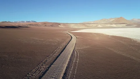 Flying over off road track on limit with desert and salar landscape Stockbeeldmateriaal 103443483