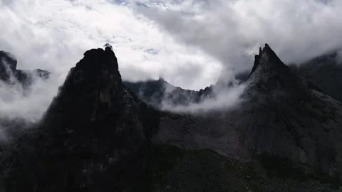 Flying over rocks in the form of a parabola in the clouds Stock Footage 290848385