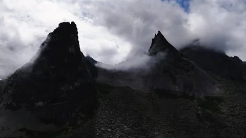 Flying over rocks in the form of a parabola in the clouds Stock Footage 290848388