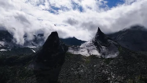 Flying over rocks in the form of a parabola in the clouds Stock Footage 290848458
