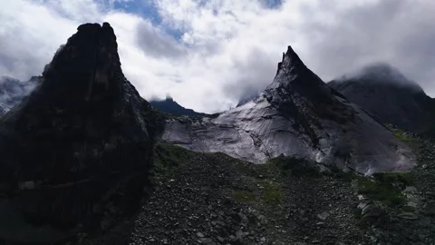 Flying over rocks in the form of a parabola in the clouds Stock Footage 290848466