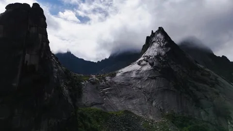 Flying over rocks in the form of a parabola in the clouds Stock Footage 290848490