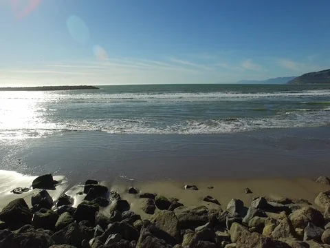 Flying over rocks into ocean Stock Footage 72491566