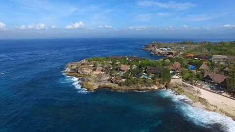 Flying over rocky ledge with luxury villas pools Stock Footage 111778736