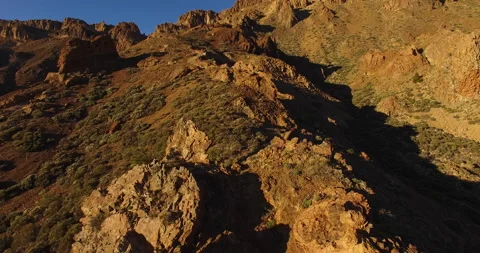 Flying over a rocky mountain peak on a drone. Stock Footage 237480096
