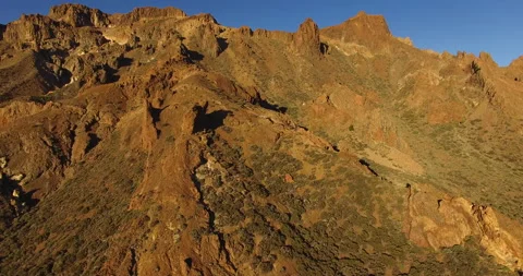 Flying over a rocky mountain peak on a drone. Stock Footage 237480291