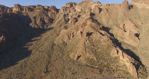 Flying over a rocky mountain peak on a drone. Stock Footage 237480764