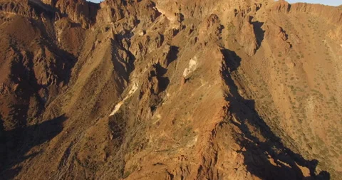 Flying over a rocky mountain peak on a drone. Stock Footage 237481008