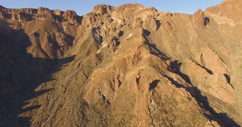 Flying over a rocky mountain peak on a drone. Stock Footage 237481194