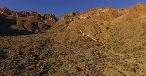 Flying over a rocky mountain peak on a drone. Stock Footage 237481620