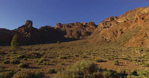 Flying over a rocky mountain peak on a drone. Stock Footage 237481671