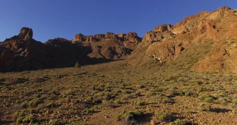 Flying over a rocky mountain peak on a drone. Stock Footage 237481684