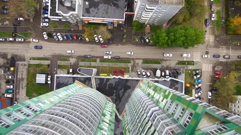 Flying over the roofs of two green skyscrapers.View from above. Stock Footage 131765488