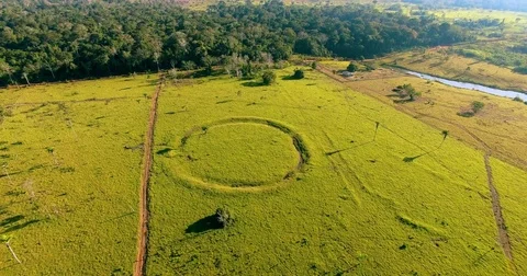 Flying over round geoglyph in Amazon rainforest Stock Footage 76976285