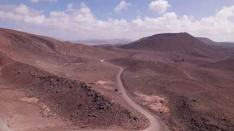 Flying Over Rugged Red Volcanic Terrain in Fuerteventura Stock Footage 309656350