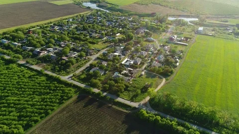 Flying over a Russian village, in the summer among fields, gardens and lakes. Un Stock Footage 125338053