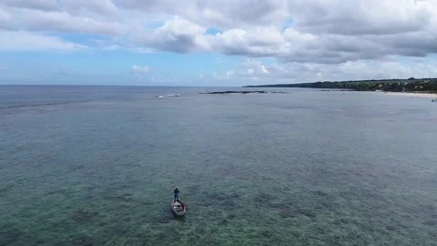 Flying over a sailing man with old boat Stock Footage 147622223