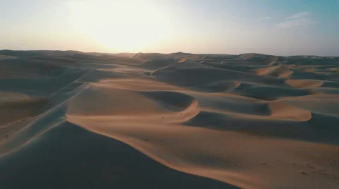 Flying over sand dunes at dusk with long shadows on the sand Vídeo Stock 55517587