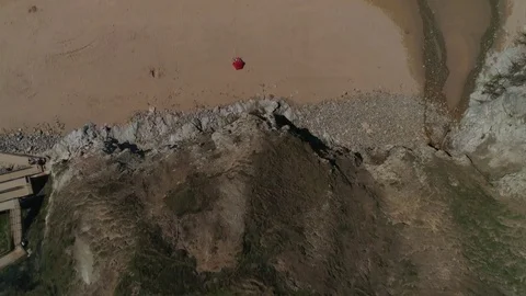Flying over a sandy beach and out into the sea, aerial seaside view Stock Footage 77506841