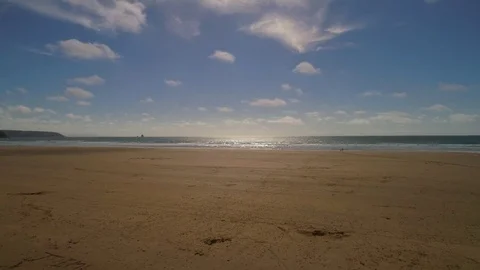 Flying over a sandy beach and out into the sea, aerial seaside view Stock Footage 77507449