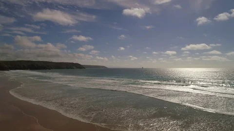 Flying over a sandy beach and out into the sea, aerial seaside view Stock Footage 77507564