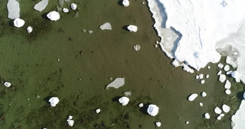 Flying over sandy beach with rolling waves and drifting ice floes in winter sea. Stock Footage 86477487