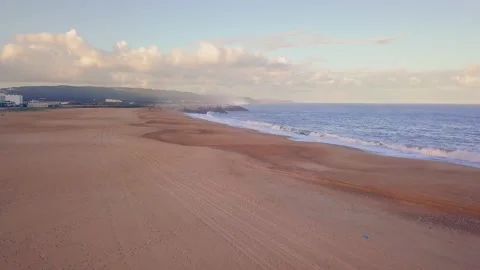 Flying over a sandy beach. Waves break on a sandy beach on the Atlantic coast Stock Footage 131838075