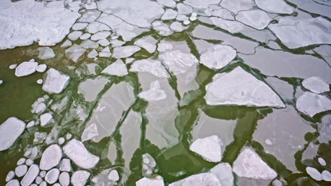 Flying over scattered ice chunks covering the surface of Lake Superior in 스톡 동영상 339074884