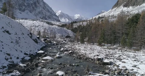Flying over scenic mountain river in the area of ​​glacier near mountain Aktru Stock Footage 143900243