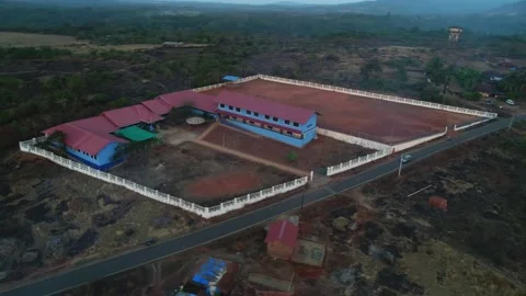 Flying over a school and school yard in small village in Goa, India. Drone view. Stockbeeldmateriaal 85511851